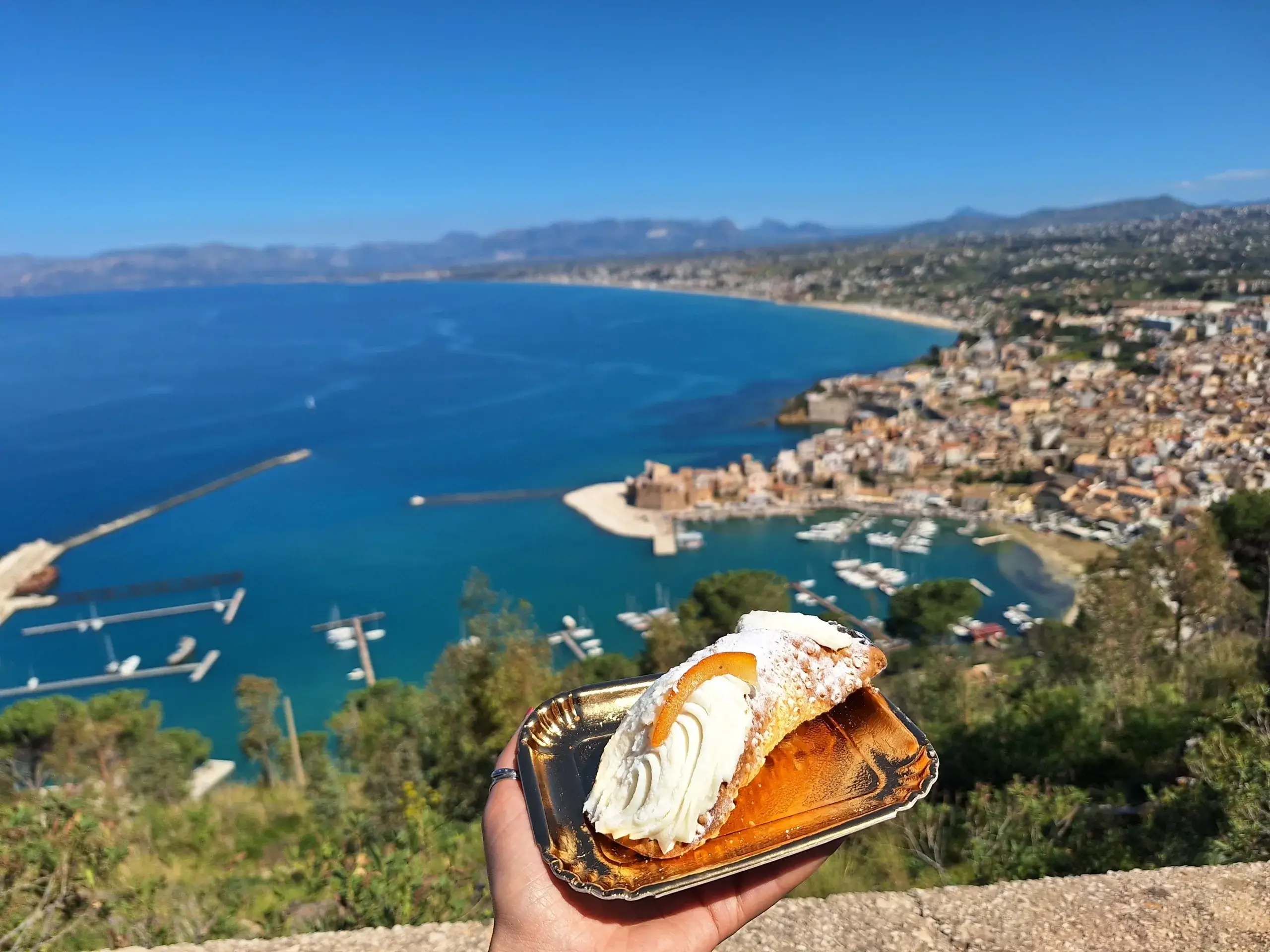 Sicilian dessert Cannolo with a beautiful view