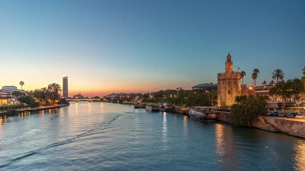 The Guadalquivir River flows through the city, bringing Seville together in golden evening light.