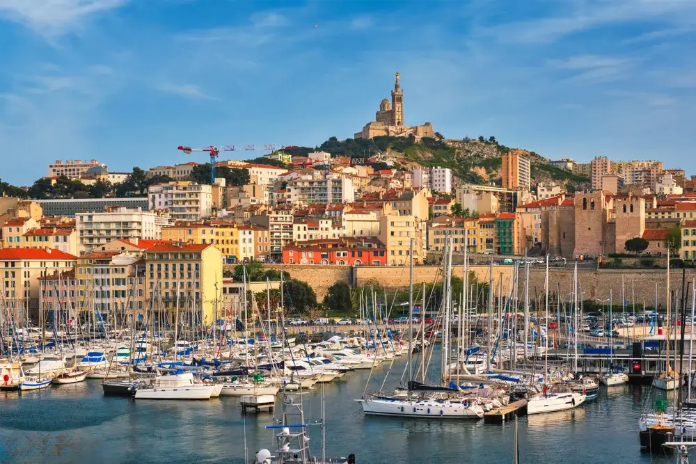 The old harbour in Marseille is full of life, with cafes, fishing boats and views of Notre-Dame de la Garde.