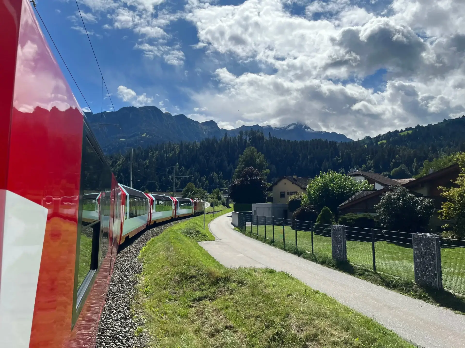 Glacier Express travelling through the Swiss Alps with mountains and valleys